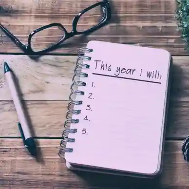 A notebook with the words " this year i will ".