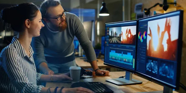 A man is working on his computer at the desk.